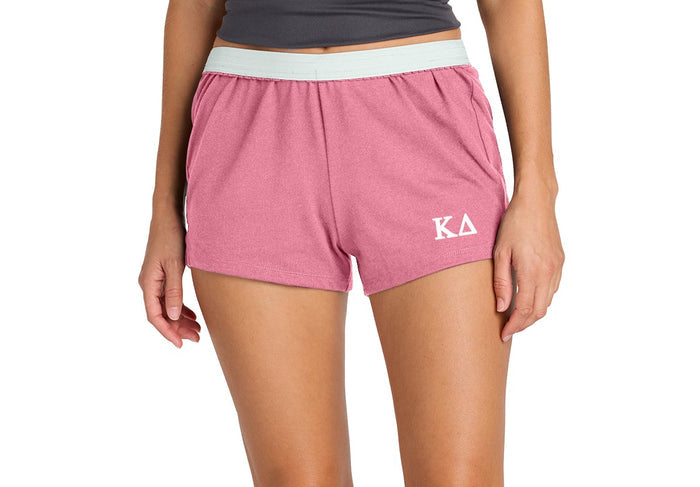 Person wearing pink shorts with a logo on a white background